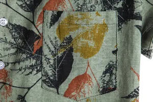 Close-up of pocket and leaf pattern on a vintage men's short sleeve linen shirt