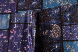 Detailed macro view of the blue patchwork floral pattern on breathable linen fabric.
