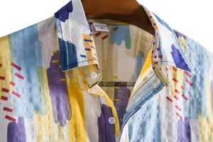 Close-up detail of men's casual short-sleeve shirt with colorful abstract print