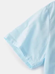 Close-up detail of light blue cotton linen men's shirt short sleeve stitching texture