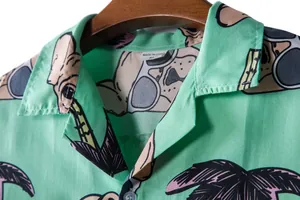 Close-up of green Hawaiian shirt collar showing Bulldog and palm tree print detail.