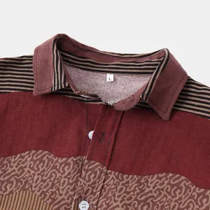 Close-up detail of ethnic pattern men's shirt featuring striped collar and burgundy fabric