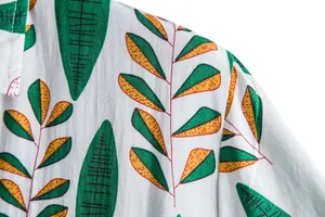 Close-up of artistic tropical leaf pattern on men's casual short-sleeved floral shirt
