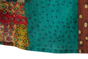 Close-up detail of men's casual linen shirt fabric with colorful ethnic patterns