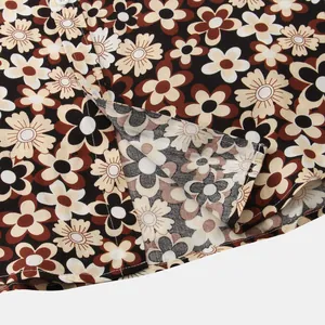 Macro view of retro floral daisy pattern on a black men's short sleeve button down shirt