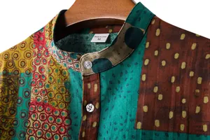 Close-up detail of men's casual linen shirt with stand collar and ethnic floral pattern.