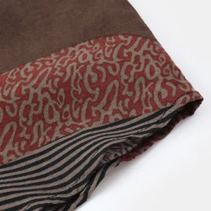 Close-up detail showing the ethnic print and striped fabric of a men's casual shirt
