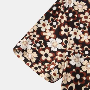 Detailed close-up of a men's short sleeve shirt featuring a retro daisy floral pattern