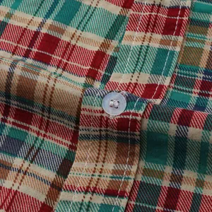 Close-up of colorful plaid pattern and button on men's casual Hawaiian beach shirt fabric.