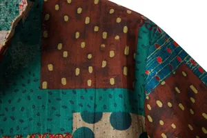 Detailed macro view of men's linen patchwork shirt with vibrant colorful patterns