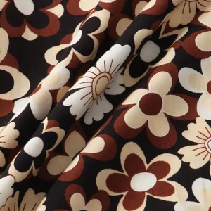 Close-up of retro floral fabric on a men's vintage brown short-sleeve shirt