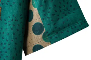 Close-up of high-quality linen fabric texture and stitching on men's floral shirt sleeve