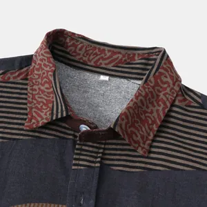 Close-up detail of ethnic tribal pattern and fabric texture on men's casual shirt collar