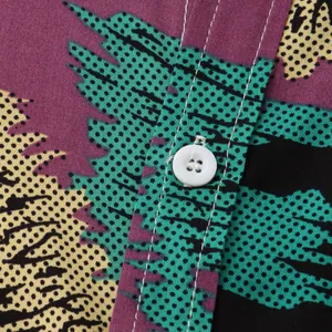 Close-up detail of pop art halftone print and white button on men's short-sleeved shirt