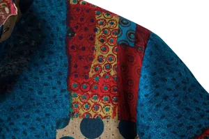 Close-up of men's linen shirt shoulder showing vibrant ethnic geometric print and fabric texture