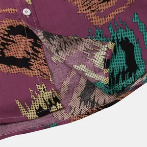 Macro detail of men's summer floral shirt showing fabric texture and hem stitching.