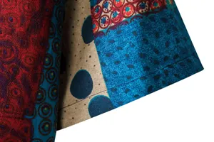 Macro detail of men's linen-like casual shirt with vibrant floral patchwork pattern