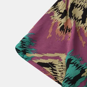 Close-up of vibrant abstract halftone pattern and fabric texture on men's short sleeve shirt