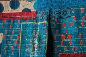 Macro detail showing the patchwork floral pattern and linen texture of a casual shirt.