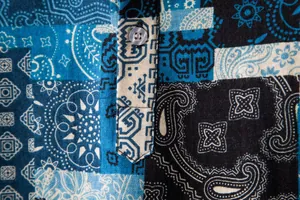Detailed macro view of men's linen shirt featuring vintage paisley pattern and a button