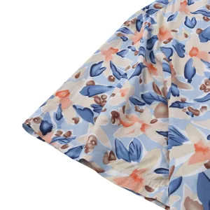Detailed macro shot of the sleeve and blue floral pattern on a men's Hawaiian beach shirt