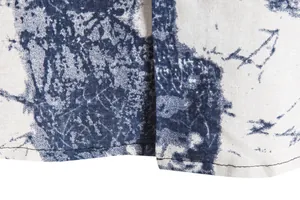 Detailed macro view of blue abstract batik print and hem stitching on retro shirt