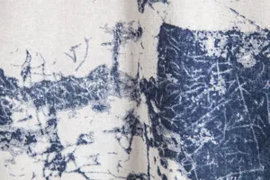 Macro close-up of vintage Hawaiian blue abstract print on white woven fabric texture
