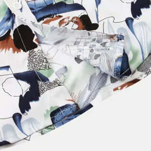 Close-up detail of abstract floral print on men's short-sleeve shirt showing stitching