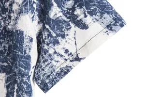 Close-up of short sleeve detail on men's retro blue and white Hawaiian print shirt