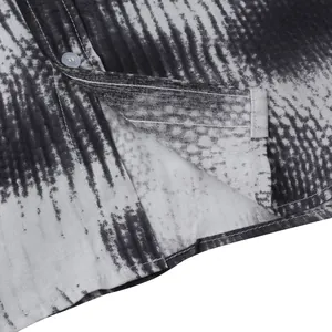 Detailed close-up of a men's tie-dye Hawaiian beach shirt with clear button texture.