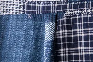 Macro detail of blue patchwork patterns on a casual linen-blend men's shirt