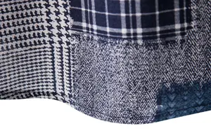 Macro detail of patchwork patterns on a navy blue linen blend casual men's shirt