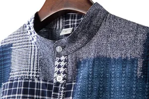Close-up of blue patchwork pattern men's mandarin collar shirt fabric texture