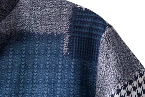 Macro view of blue cotton-linen shirt featuring patchwork herringbone and houndstooth patterns