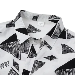 Close-up detail of a white men's Hawaiian shirt with black geometric patterns and collar