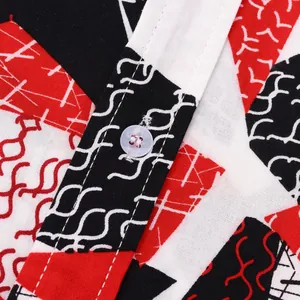 Macro view of men's geometric pattern shirt showing fabric texture and white button