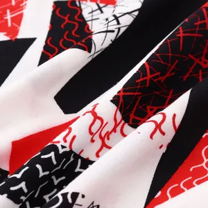 Close-up detail of soft fabric with red black and white geometric abstract print