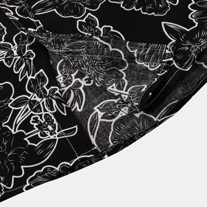 Close-up of black and white floral print fabric and hem stitching on men's shirt