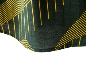 Detailed macro shot of men's casual linen shirt hem with yellow geometric line pattern