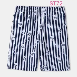 Detailed view of men's striped beach shorts featuring a navy anchor print and drawstring.
