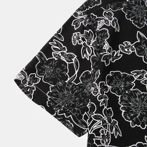 Detailed macro view of men's short sleeve floral shirt with black and white print pattern