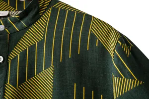 Close-up detail of a men's dark green linen shirt with yellow geometric stripe patterns.