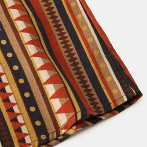 Close-up of ethnic tribal pattern fabric on a men's casual long sleeve shirt detail view.