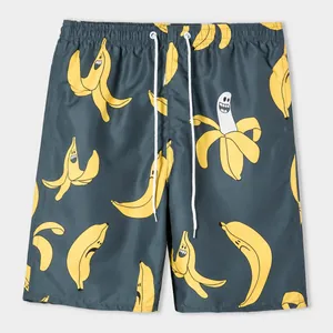 Detailed view of men's loose beach shorts with cartoon banana and letter print