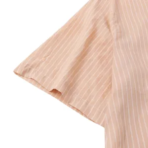 Close-up detail of short sleeve on a light orange and white striped casual beach shirt