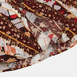 Macro detail showing the hem stitching and chain print of a men's floral short sleeve shirt.