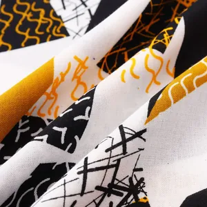 Macro view of men's slim fit shirt fabric with geometric black and yellow print
