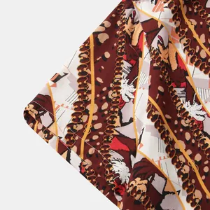 Close-up detail of mens short sleeve shirt with vintage chain and leopard print