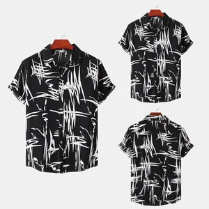 Detailed view of men's short sleeve shirt with white abstract stripe pattern on black.