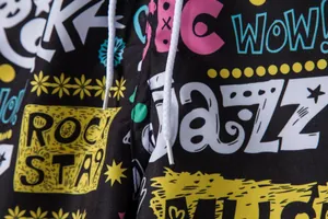 Detailed macro shot of men's beach shorts featuring vibrant colorful graffiti print patterns